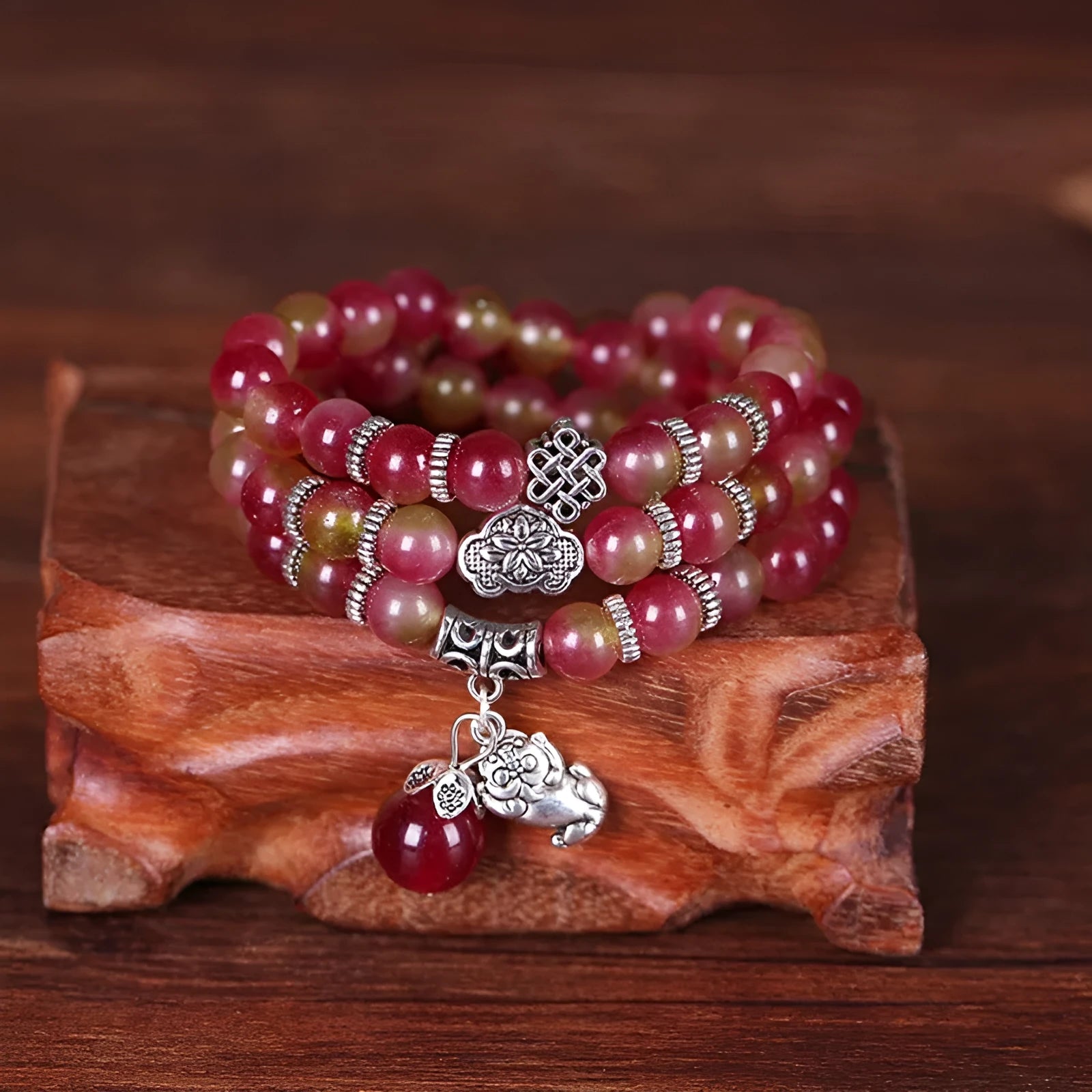 Handmade bracelet with a watermelon crystal elephant bead on a Chinese knot cord.
