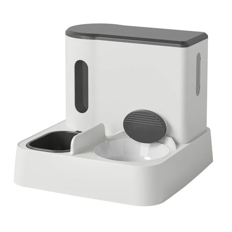 Grey automatic cat feeder and water dispenser station with integrated double bowls on a wooden floor.