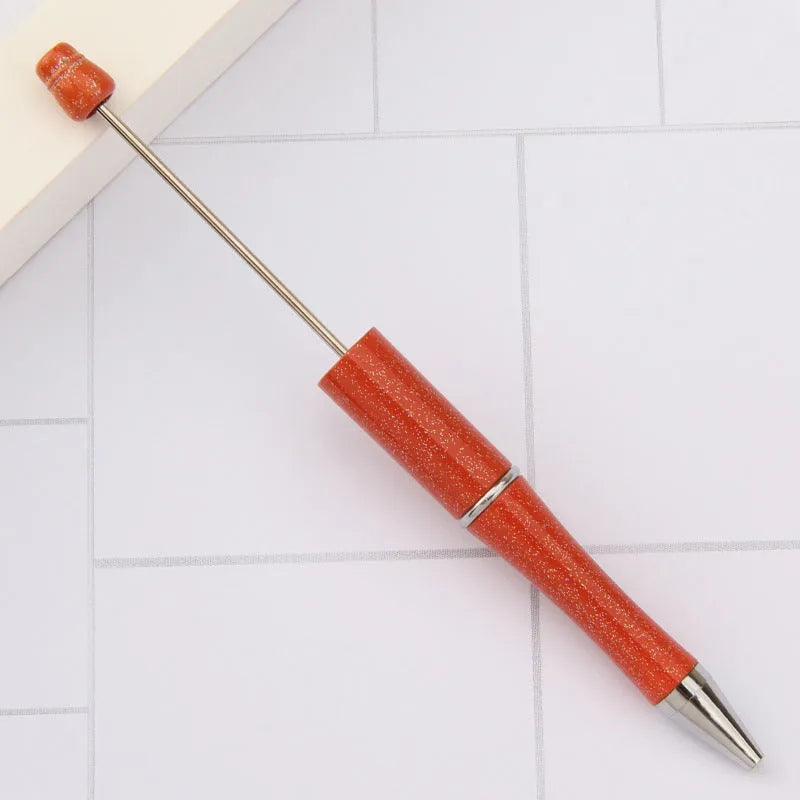 Creative ballpoint pen with multicoloured spinning plastic beads on a steel wire frame.
