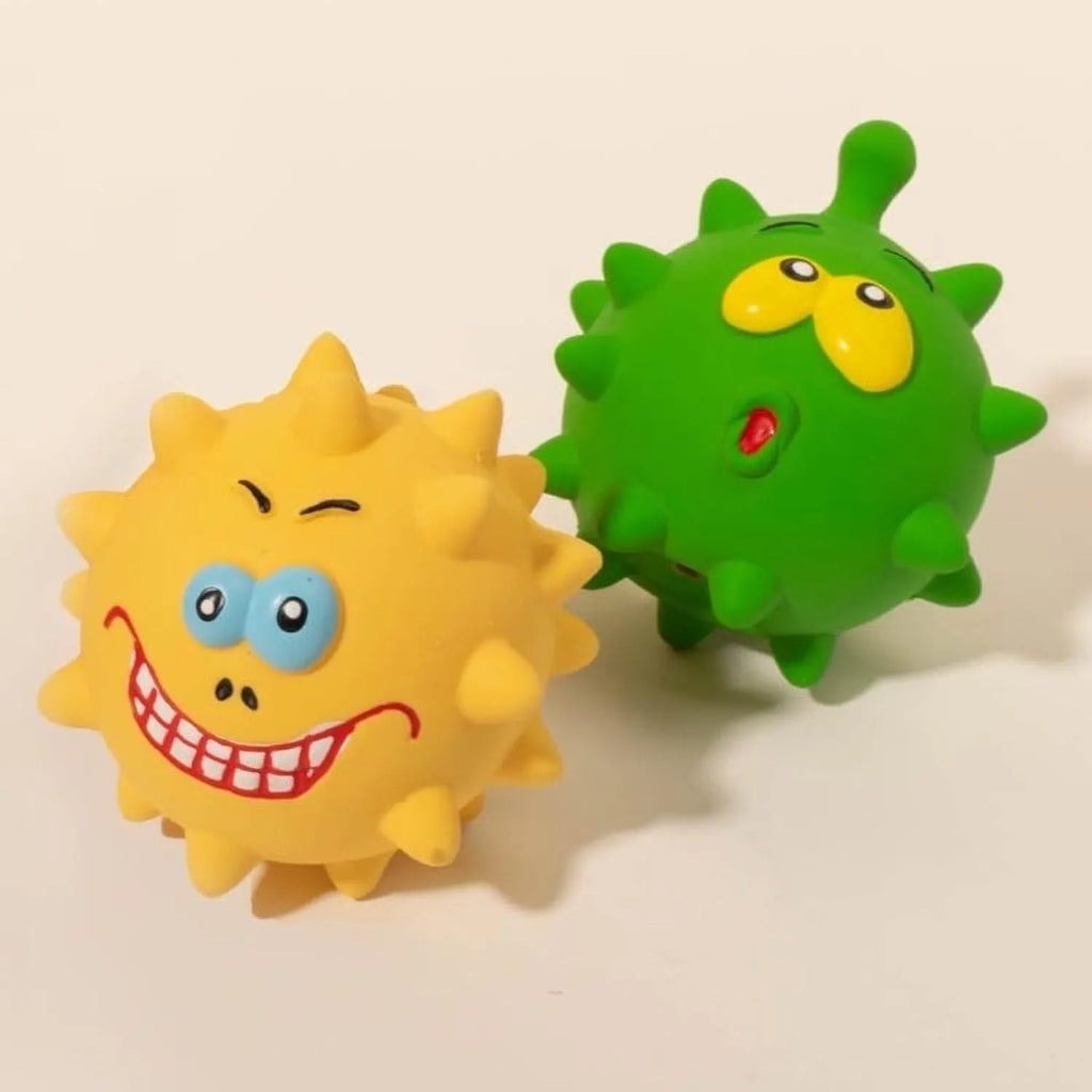 Four colourful squeaky dog balls with cute faces made from natural latex rubber with textured surfaces