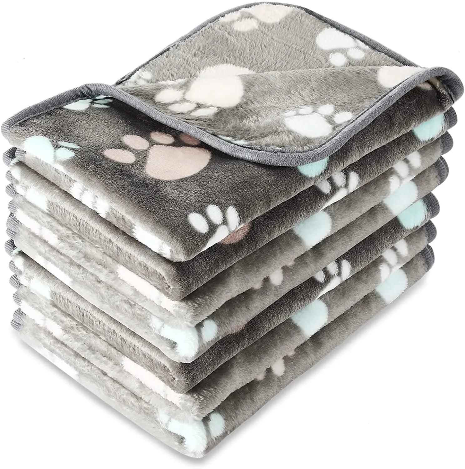 Coral fleece dog blanket with paw print pattern in beige, shown in a large size on a dog bed.