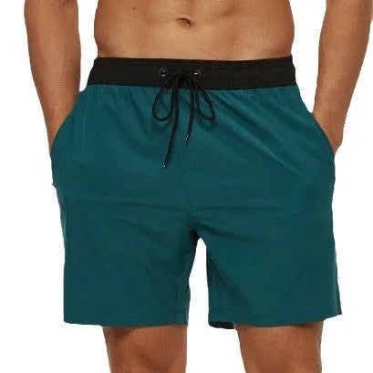 Men's blue training shorts with stitching waist detail and headband pocket for running and fitness