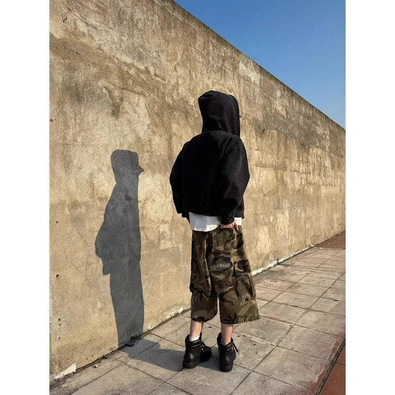 Men's camouflage pattern cropped jeans with distressed patches and straight leg cut