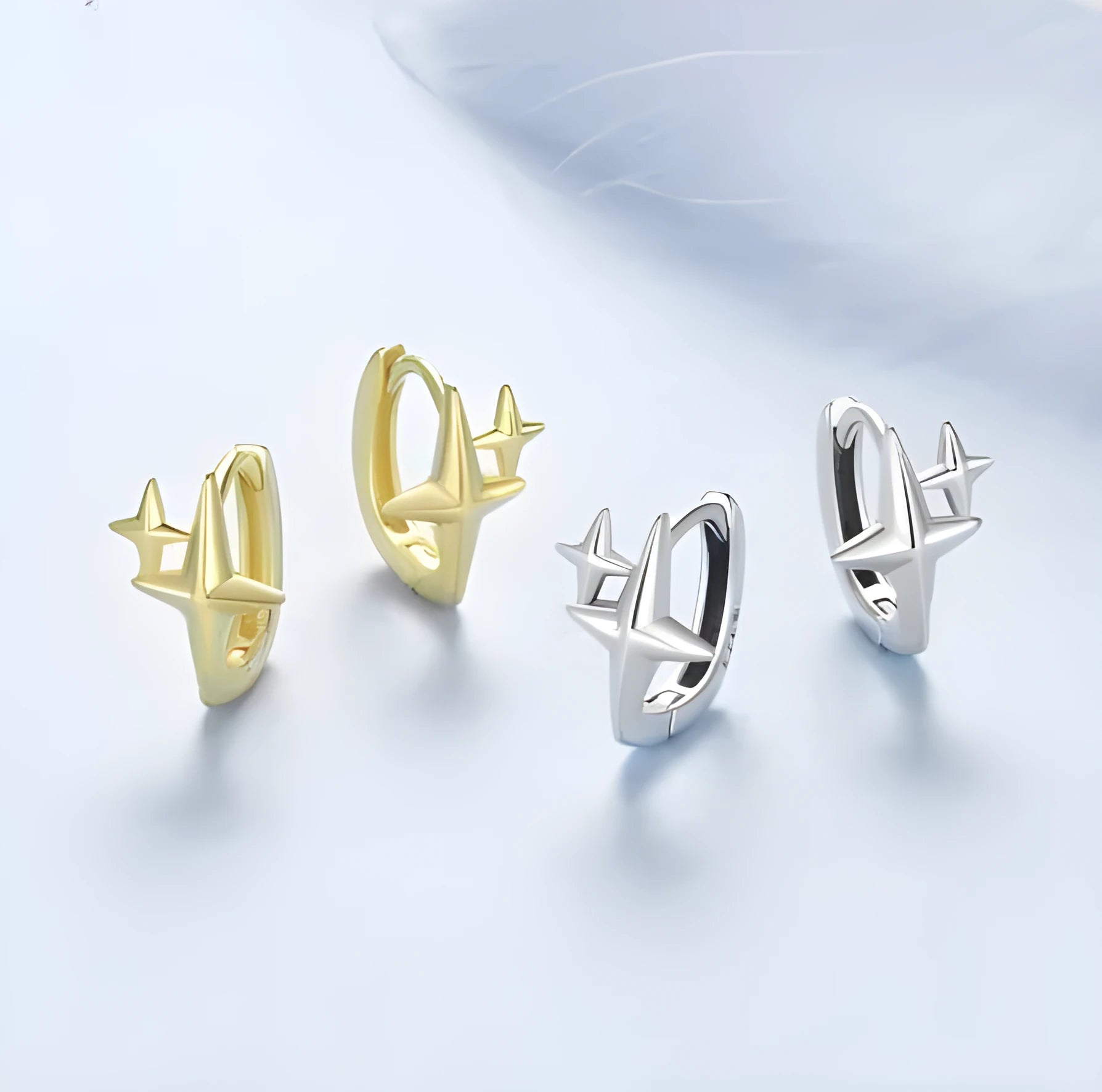 Sterling silver star clip earrings with oxidised finish and XINGX design details