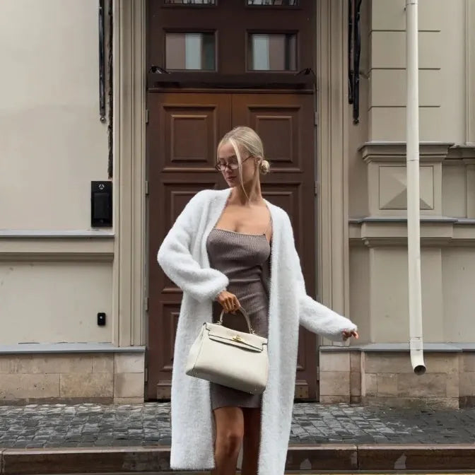White women's sweater cardigan jacket with extended length and loose fit design