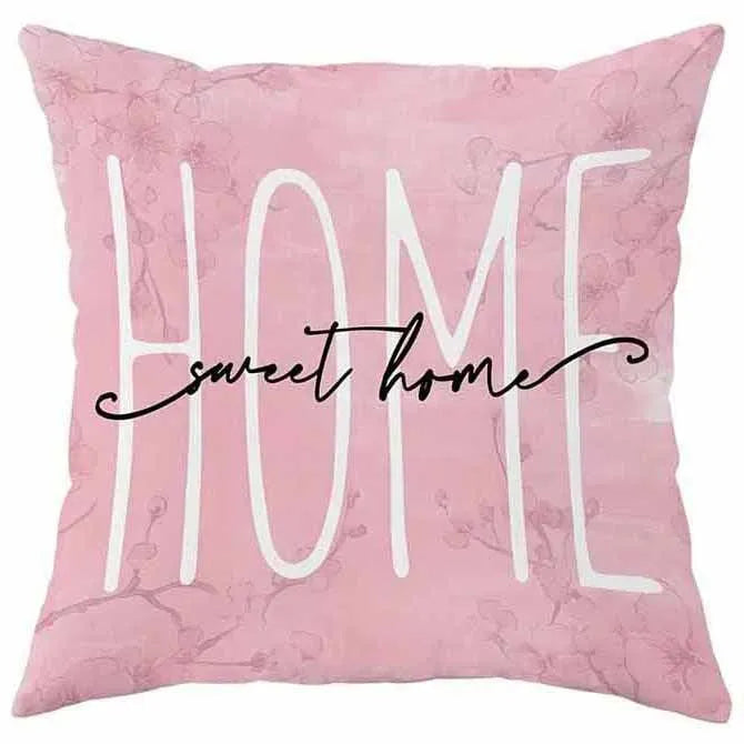 Short velvet square cushion cover with cherry blossom letter print, shown in one of four colour options.