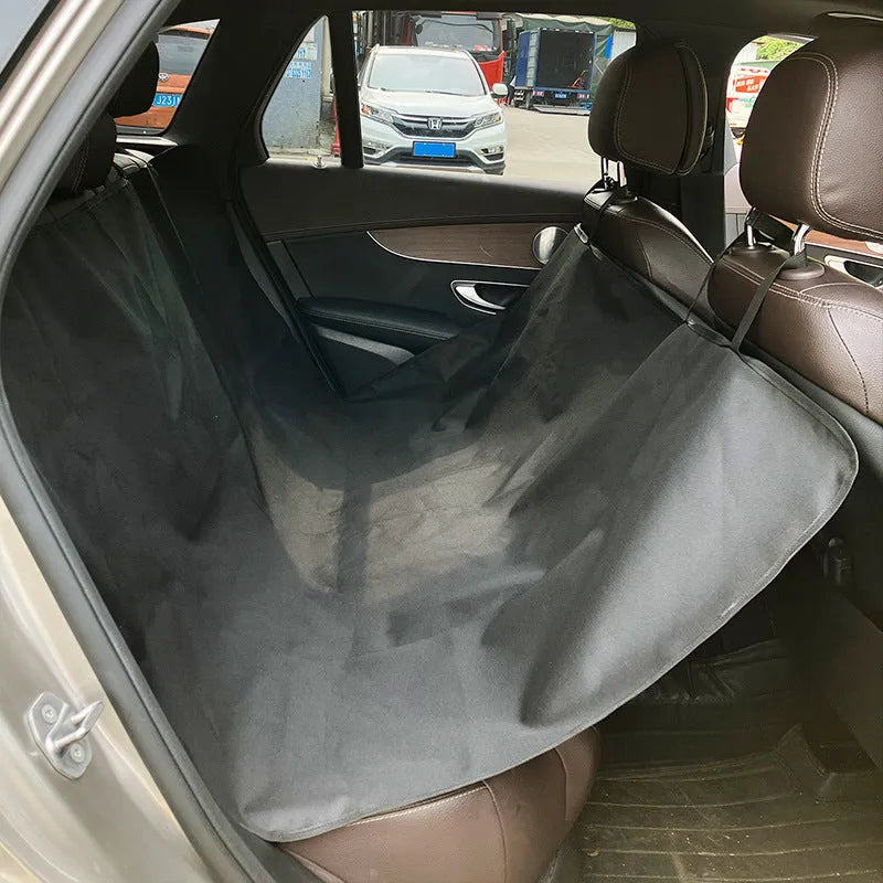 Grey car pet mat with dog bone print on rear car seat protecting upholstery