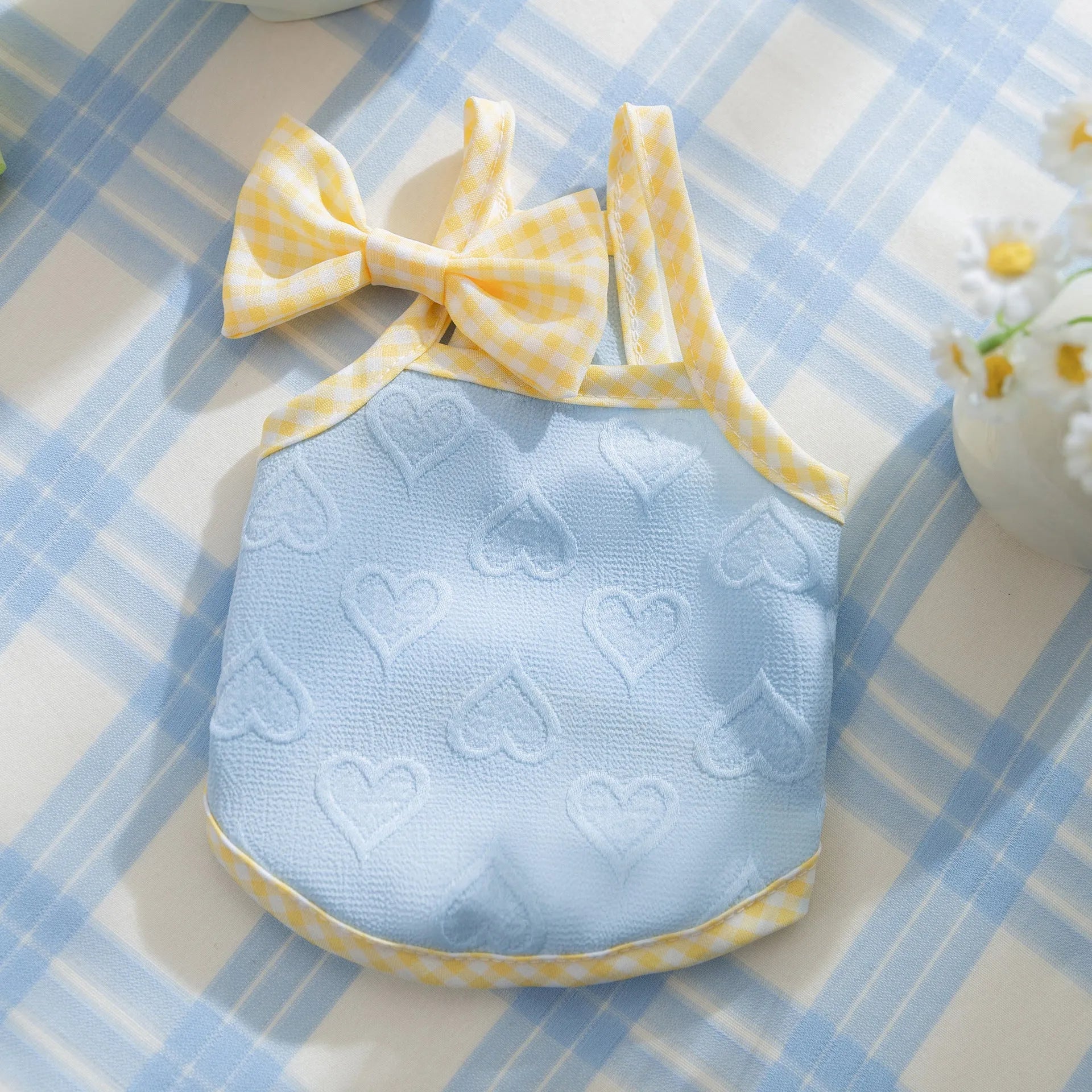 Small dog wearing heart texture elastic vest with bow suspenders in Bondi Blue colour
