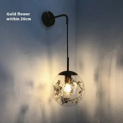 Modern glass wall lamp in golden flower or silver flower finish, shown in 15cm and 20cm sizes