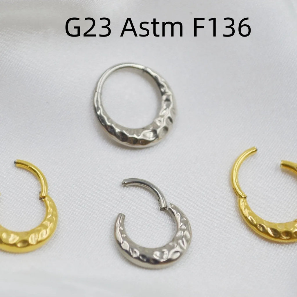 ASTM F136 titanium alloy nose ring with concave-convex carved design in gold or silver.