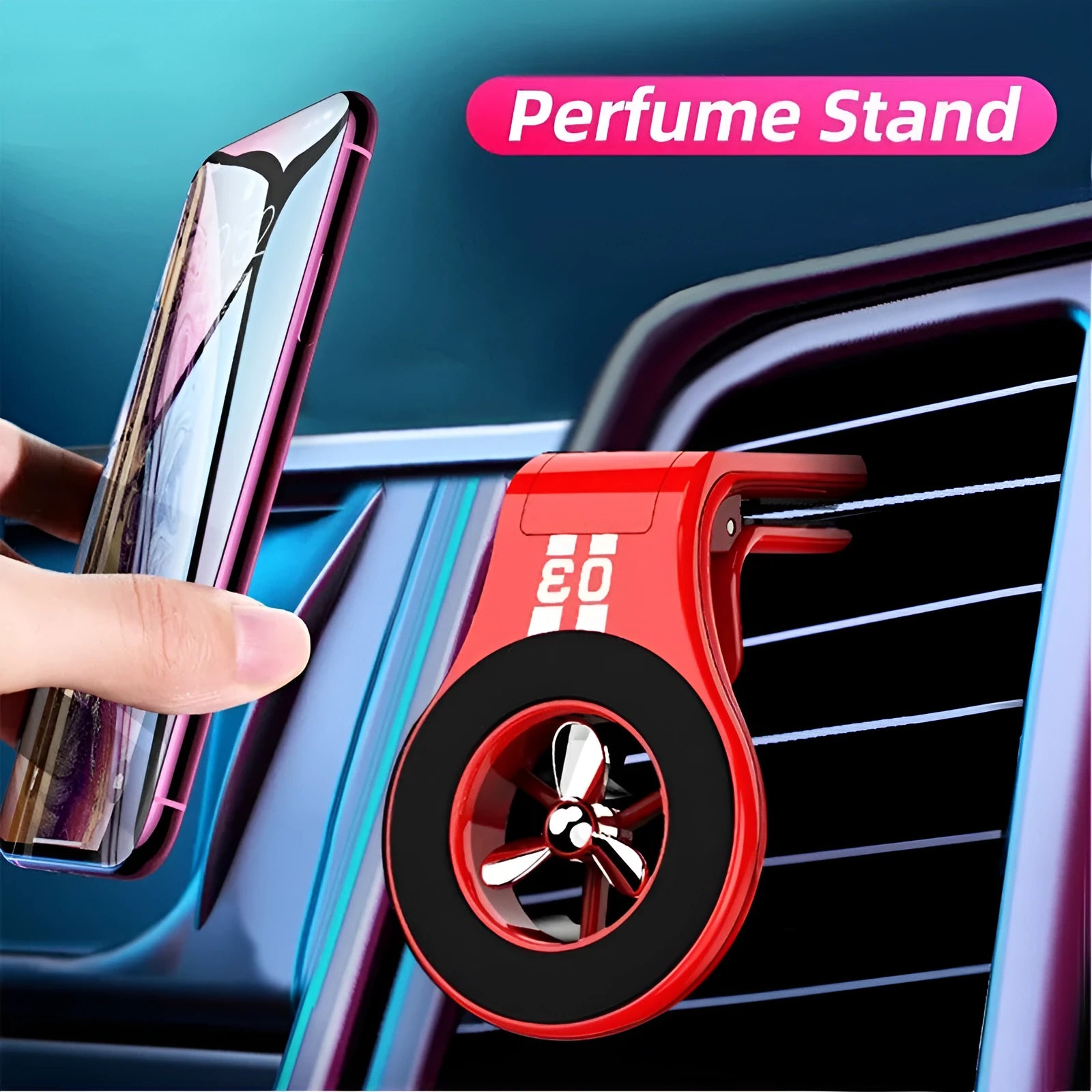 Black magnetic car phone holder clipped to a car air vent, showing a smartphone attached and the included fragrance slice.