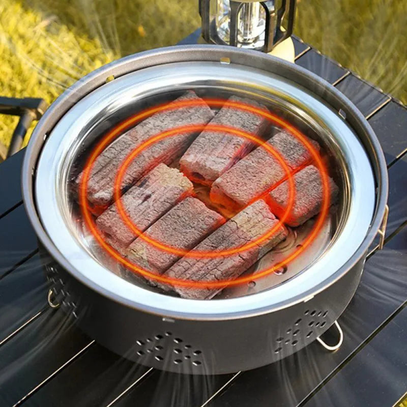 Portable stainless steel charcoal barbecue grill with detachable parts and a carry bag.