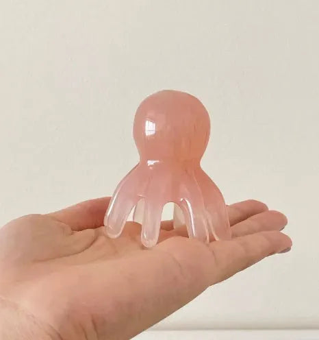 Pink natural resin octopus-shaped massage comb for face and scalp with storage bag