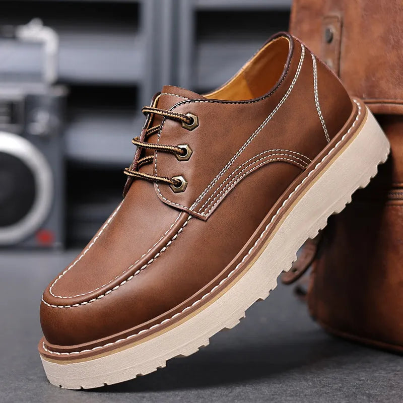 Men's black retro Martin boots with round toe and low-top design on a plain background