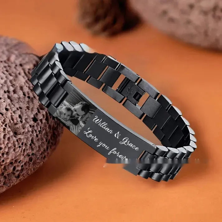 Men's titanium steel curved heart shape bracelet with black lettering.