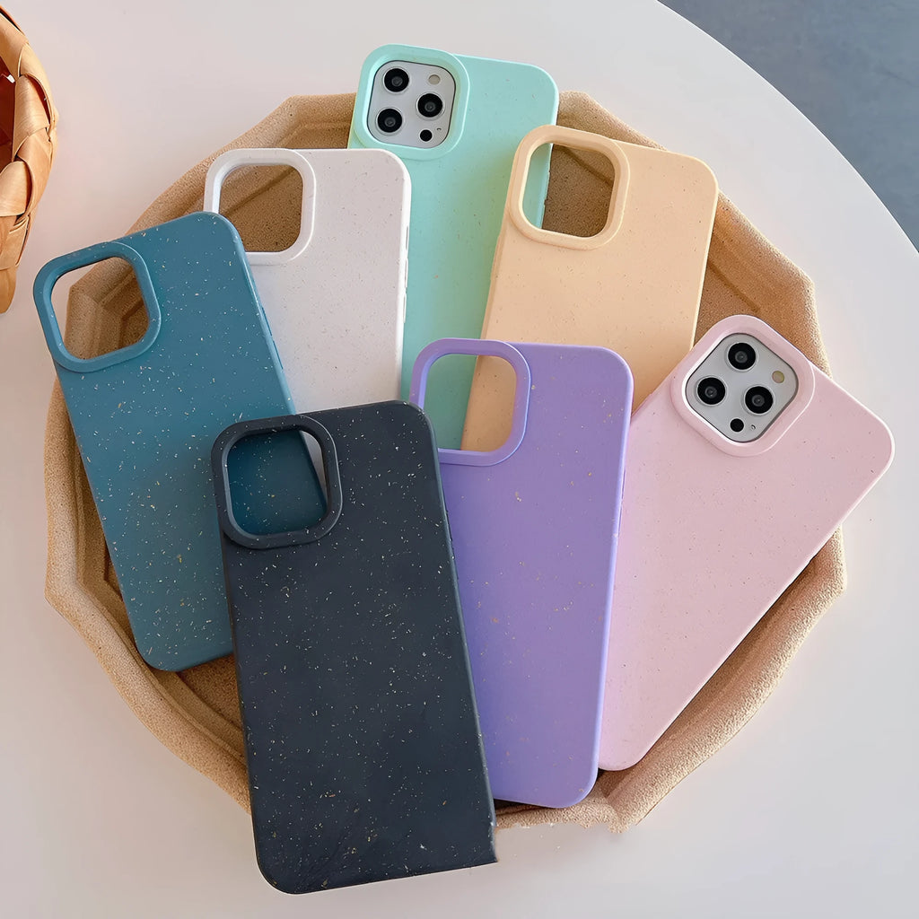 Fully degradable wheat straw bioplastic rear cover case for Apple iPhone on a table, shown in one of seven available colours.
