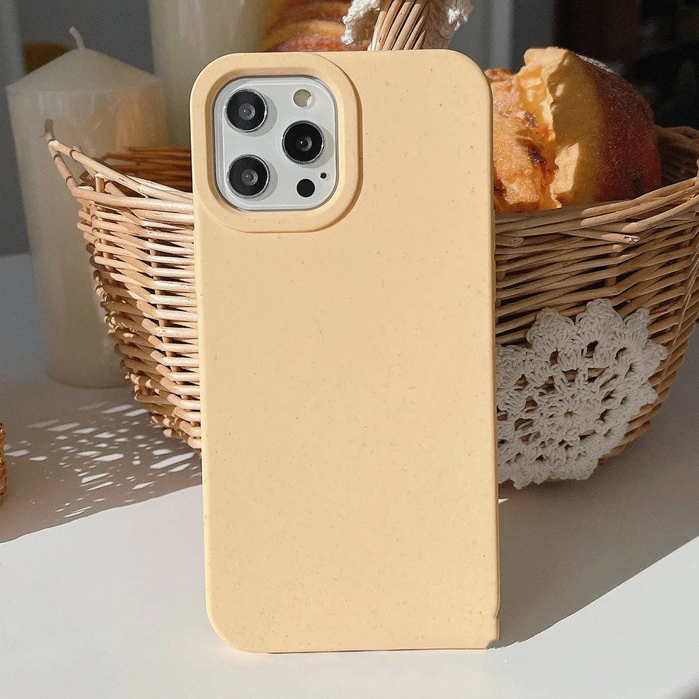 Fully degradable wheat straw bioplastic rear cover case for Apple iPhone on a table, shown in one of seven available colours.