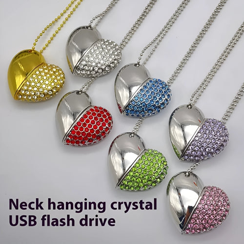 A heart-shaped silver USB flash drive with a brick pattern, shown next to a laptop.