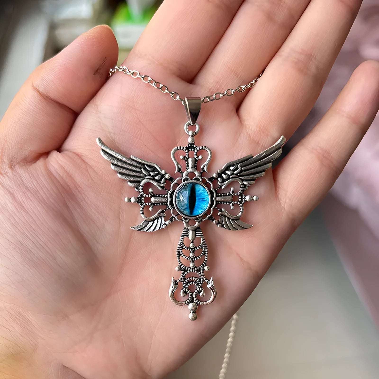 Alloy devil wings and cross geometric pendant necklace on a chain.