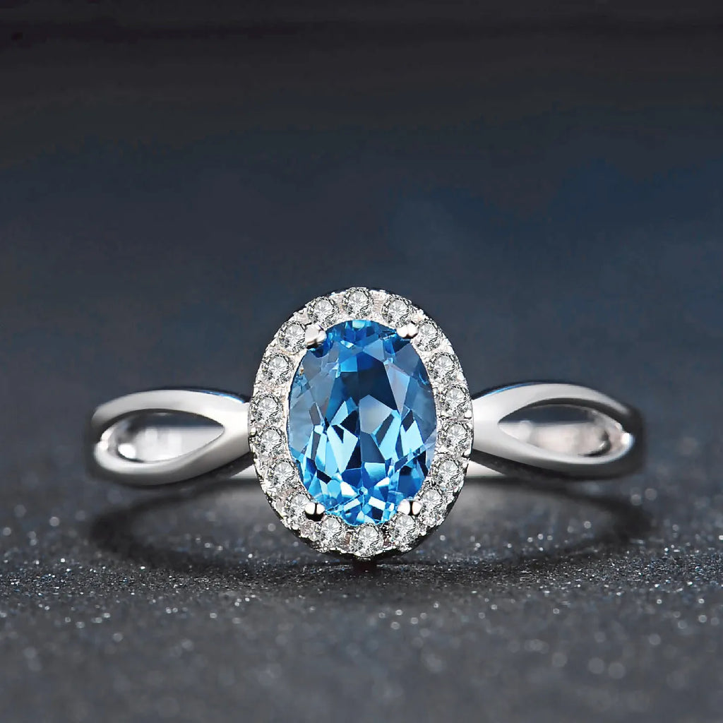 Geometric design 925 sterling silver jewellery set with blue topaz, showing earrings, ring, pendant and necklace.