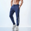 Men's grey sweatpants with ankle ties showing mid-waist design and polyester-spandex fabric