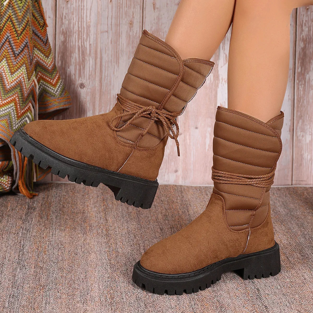 Women's black suede chunky heel snow boots with lace-up front and fleece lining.
