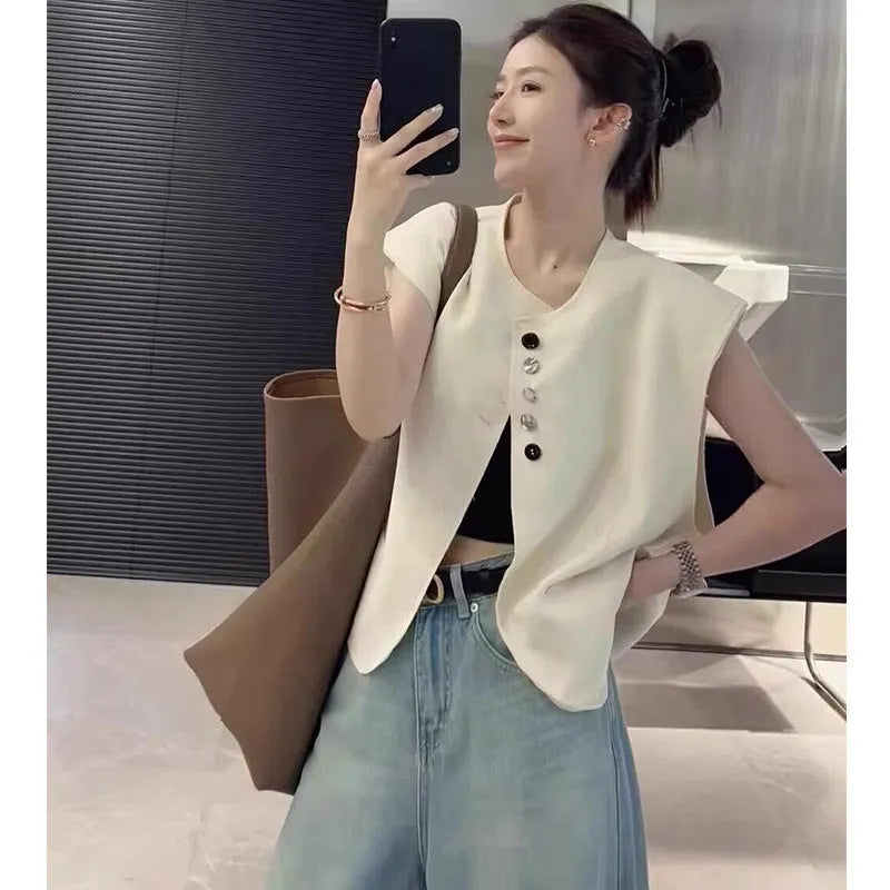 Women's loose fit polyester vest in milky white and black colours with pocket details.