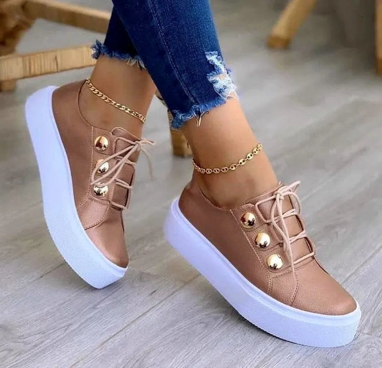 Women's lace-up flats sneakers with rivet detail, artificial PU upper, round toe, and polyurethane sole in white, black, gold, or rose gold.