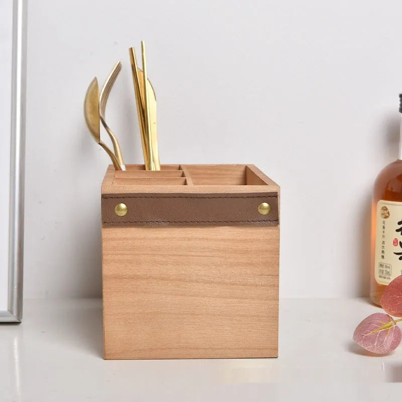 Natural wooden kitchen storage box with internal grid dividers for organising knives, forks, and chopsticks.
