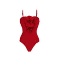 Red women's V-neck one-piece swimsuit with detachable flower and matching skirt on beach