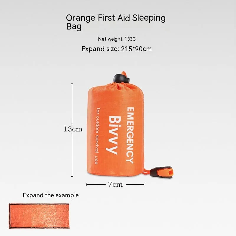 Orange portable disaster relief tent and sleeping bag kit set up outdoors.