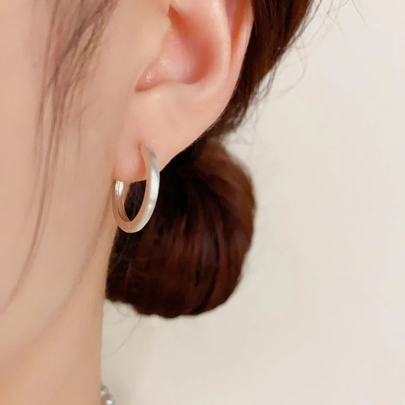 Geometric eyelet ear clips with circular design in gold or silver tone