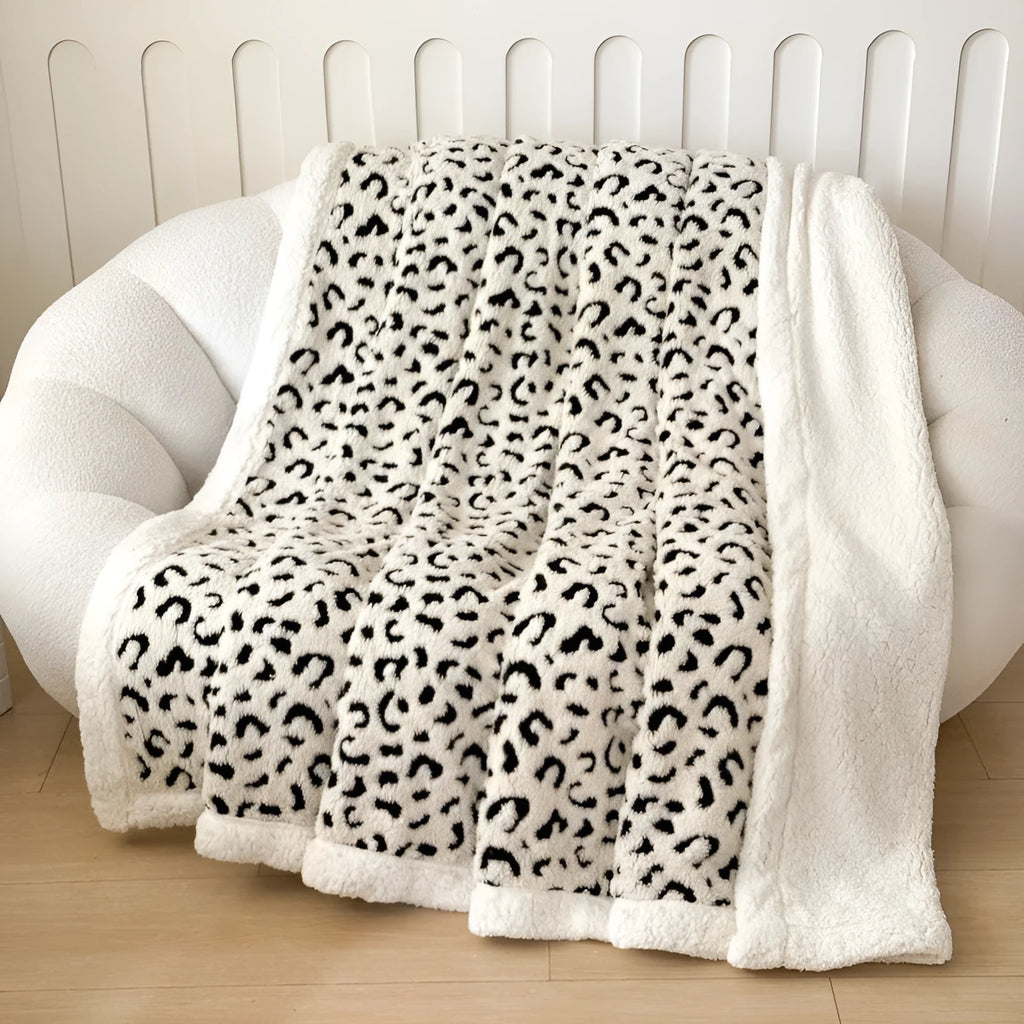 Double-layer Jacquard taffeta blanket with leopard print design in camel colour folded to show texture and pattern detail