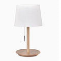 Walnut-coloured solid wood bedside lamp with white fabric shade on wooden table