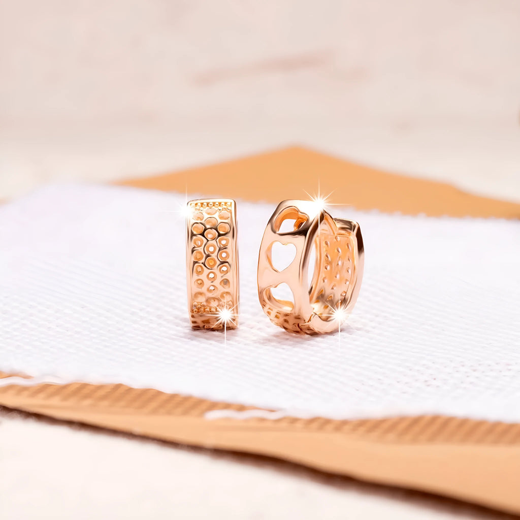 Rose gold women's earrings with three hollowed-out hearts in circular drop design