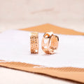 Rose gold women's earrings with three hollowed-out hearts in circular drop design