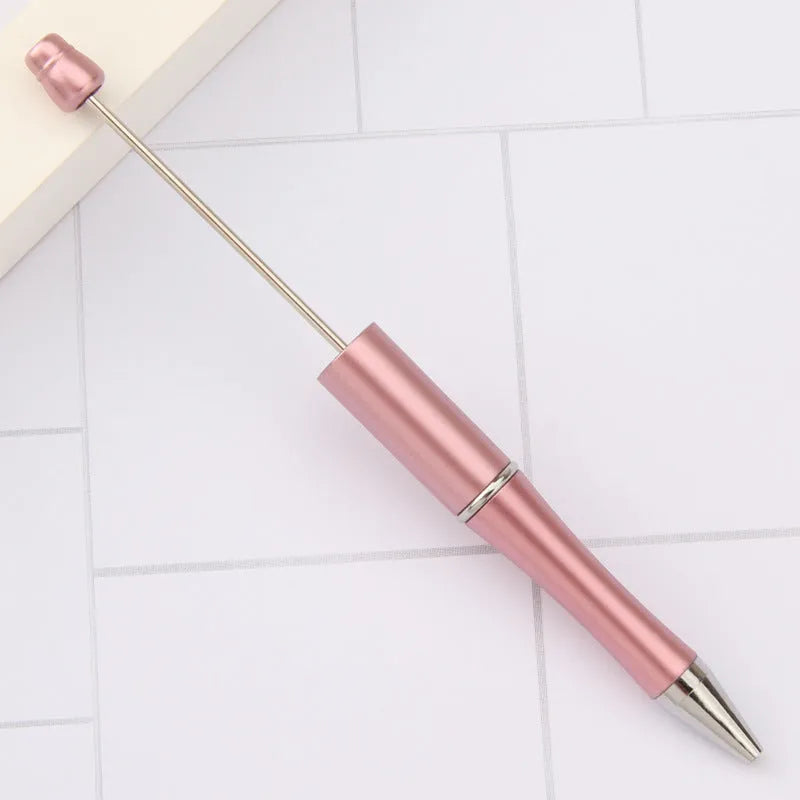 Creative ballpoint pen with multicoloured spinning plastic beads on a steel wire frame.