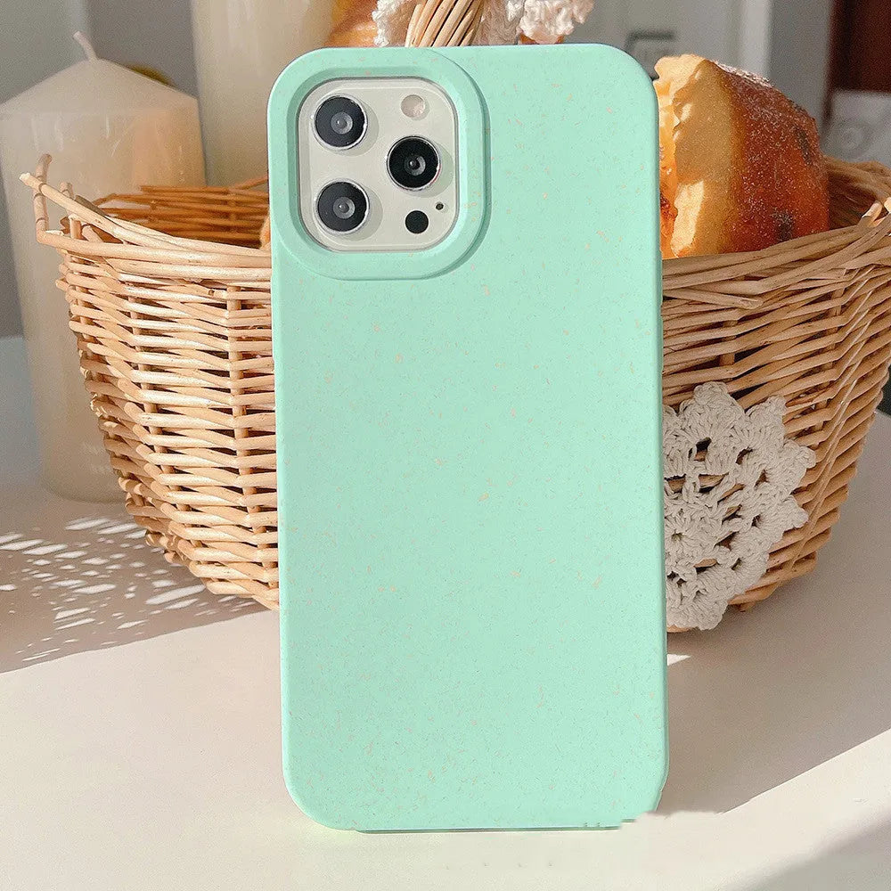 Fully degradable wheat straw bioplastic rear cover case for Apple iPhone on a table, shown in one of seven available colours.