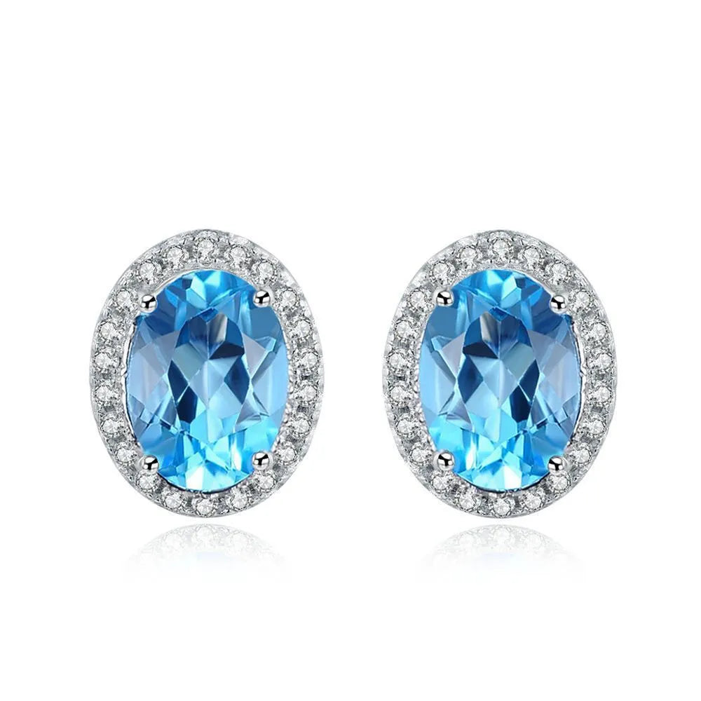 Geometric design 925 sterling silver jewellery set with blue topaz, showing earrings, ring, pendant and necklace.