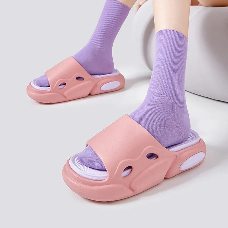 Women's and men's two-colour thick-soled EVA slippers with leather lining on a beach