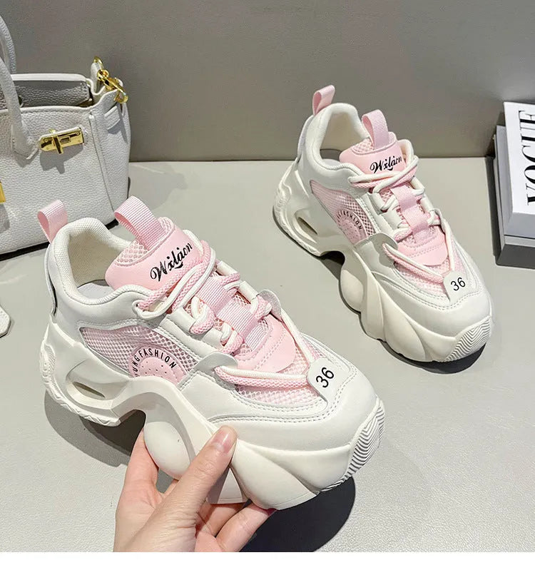 Women's casual sneakers in beige with thick sole, cross shoulder straps, and mesh lining.