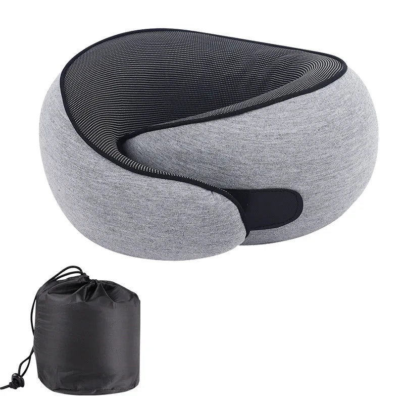 U-shaped memory foam travel neck pillow in a storage bag, shown in dark grey colour.