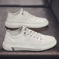 Men's white casual shoes with round toe, flat bottom, and shallow opening design