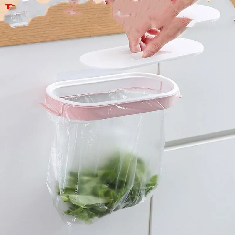 Blue plastic kitchen bin bag storage rack mounted on a cabinet door holding a roll of bags.