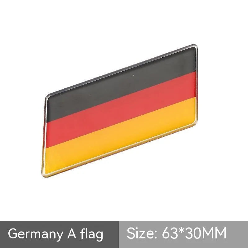 Aluminium parallelogram car sticker with national flag design measuring 6.3 by 3 cm