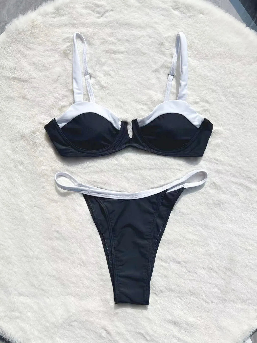 Women's black low waist bikini swimsuit with stitching detail and split brief design