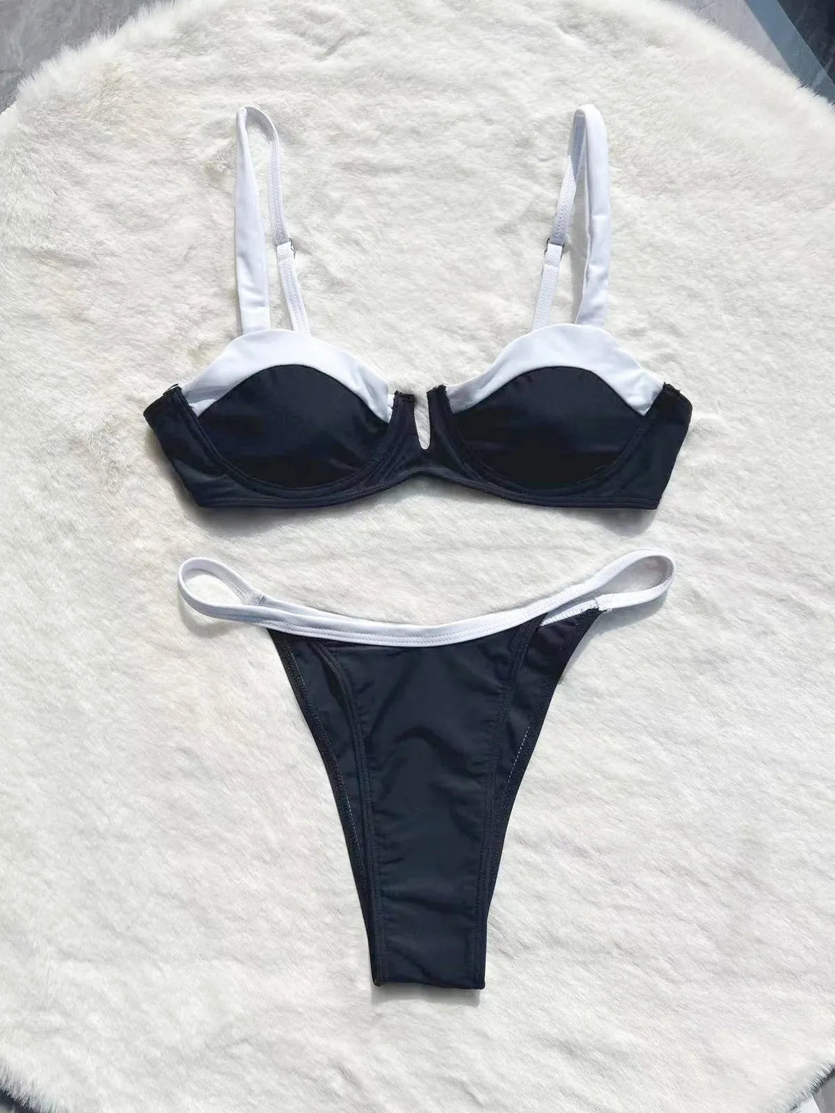 Women's black low waist bikini swimsuit with stitching detail and split brief design