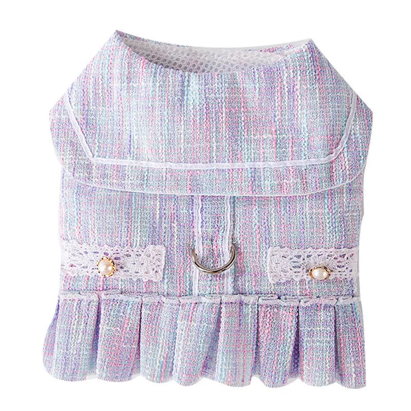 Small dog or cat wearing purple polyester pet clothing, showing the garment's fit and style.