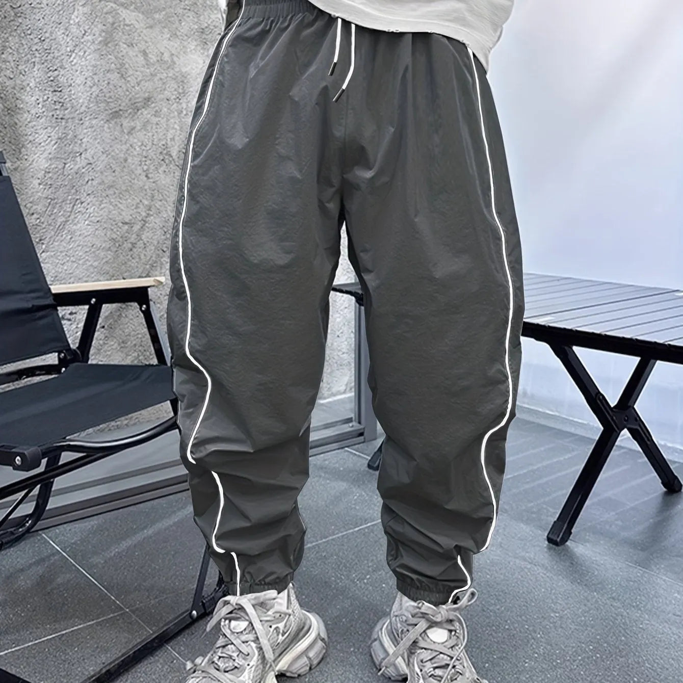 Man wearing blue bamboo fibre casual trousers with a cropped leg and loose fit.