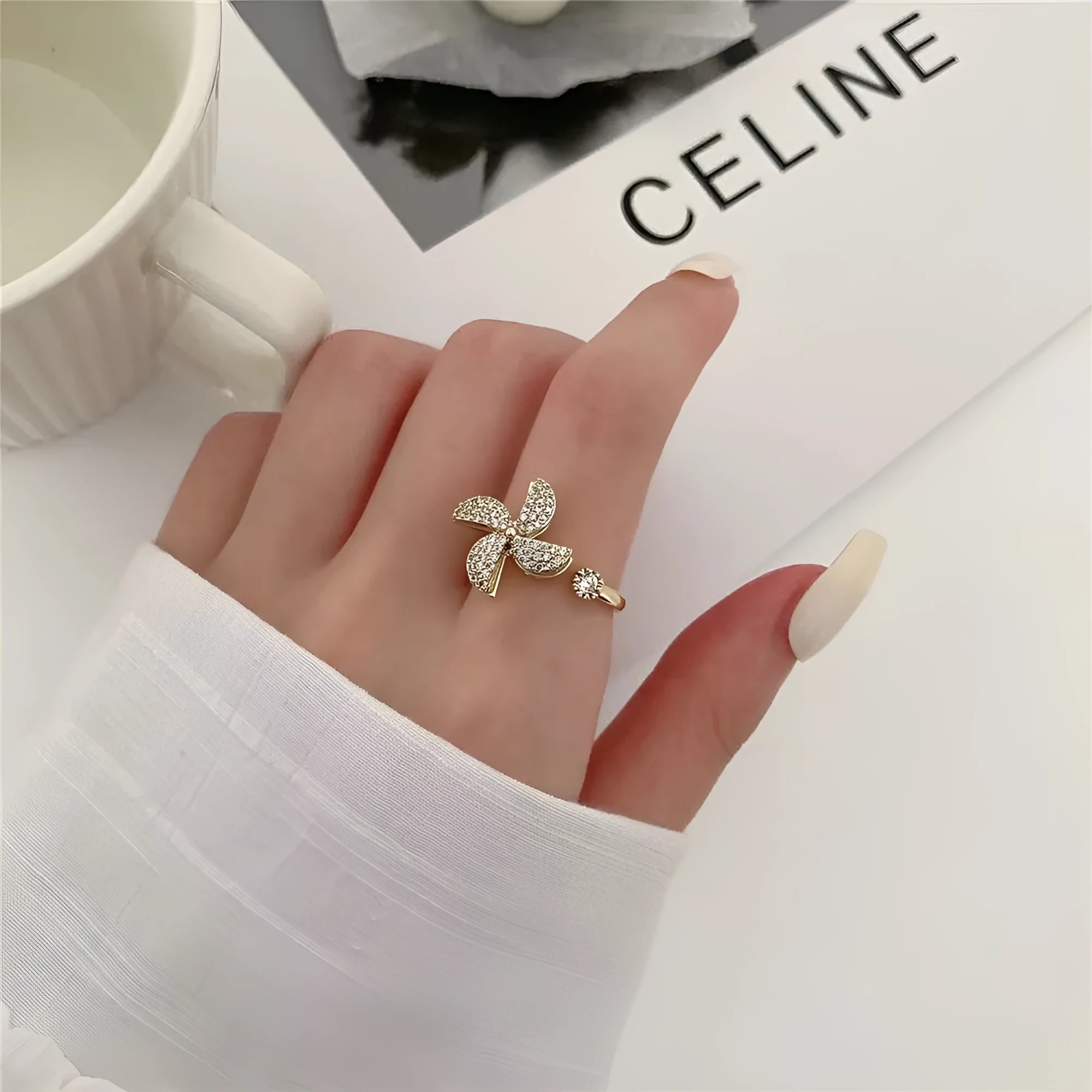 Rotating windmill ring showing golden electroplated finish on copper with geometric shape and micro inlaid design
